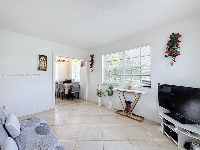 living room featuring light tile patterned floors and a notable chandelier