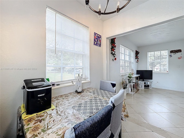 dining room with a chandelier and light tile patterned flooring