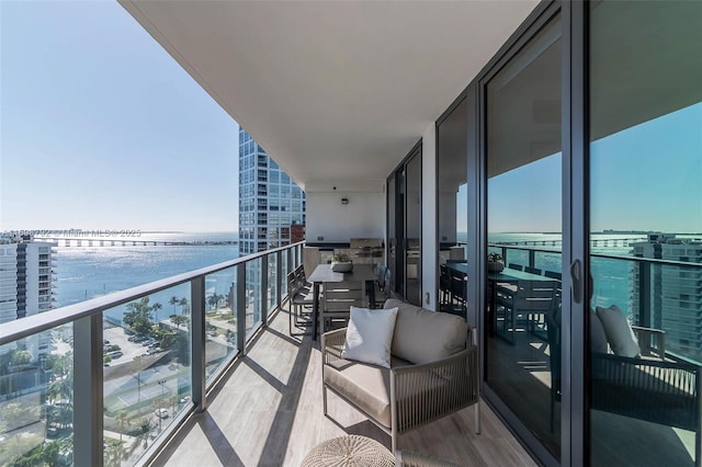 balcony featuring a water view and a beach view