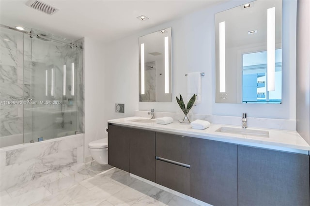 full bathroom with vanity, toilet, a wealth of natural light, and tiled shower / bath combo