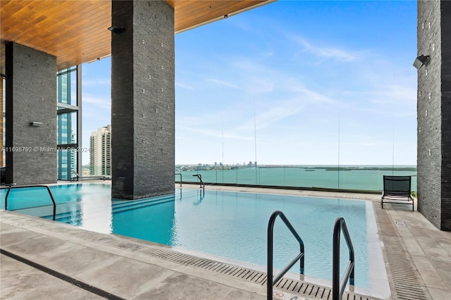 view of swimming pool with a water view