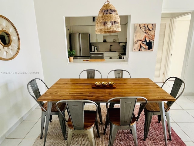 tiled dining room featuring sink