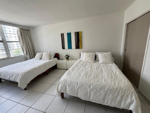 tiled bedroom featuring a closet