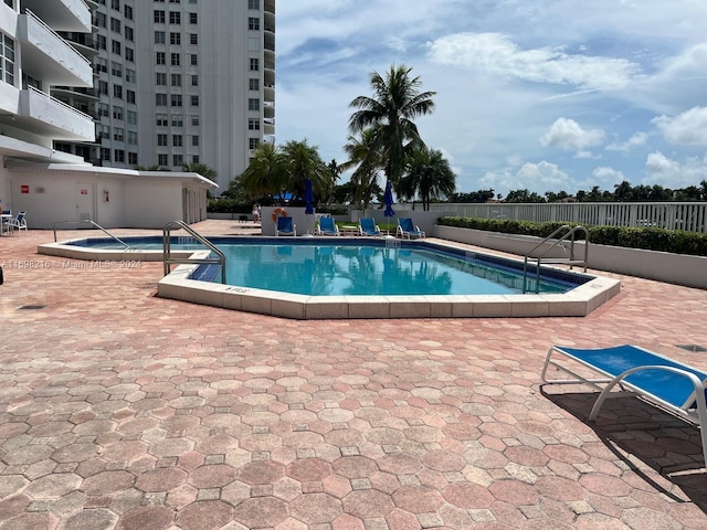 view of swimming pool with a patio