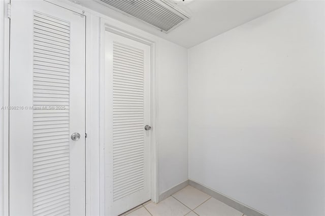 5700 Collins Ave Unit 5B, Miami Beach, FL 33140 - corridor featuring light tile patterned floors and baseboards