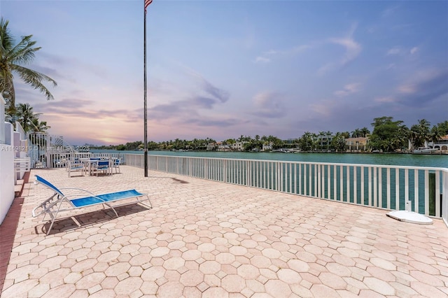5700 Collins Ave Unit 5B, Miami Beach, FL 33140 - patio terrace at dusk featuring a water view and a patio area