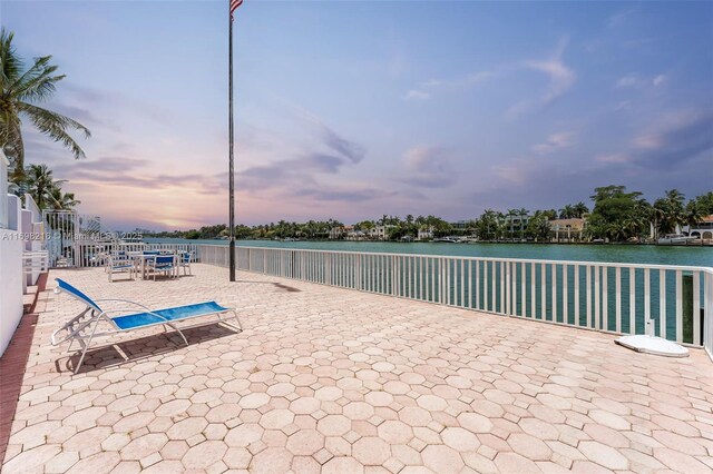5700 Collins Ave Unit 5B, Miami Beach, FL 33140 - patio terrace at dusk featuring a water view and a patio area