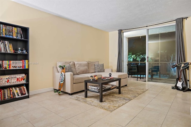 tiled living room featuring a textured ceiling