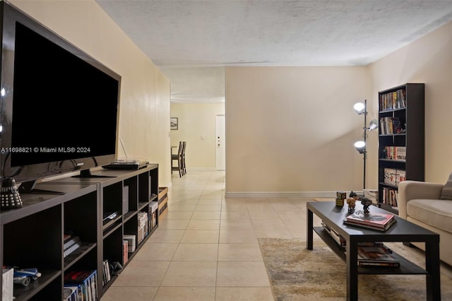 tiled living room featuring a textured ceiling