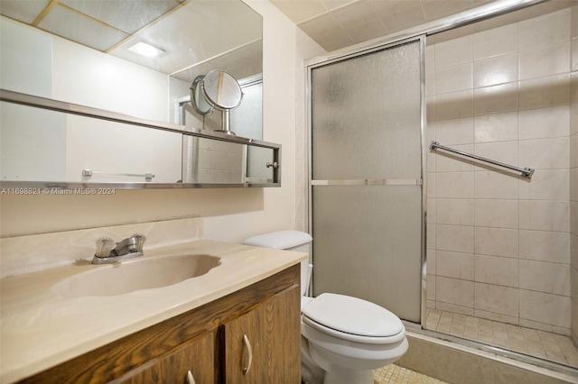 bathroom featuring vanity, toilet, and walk in shower