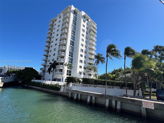 view of property with a water view and fence