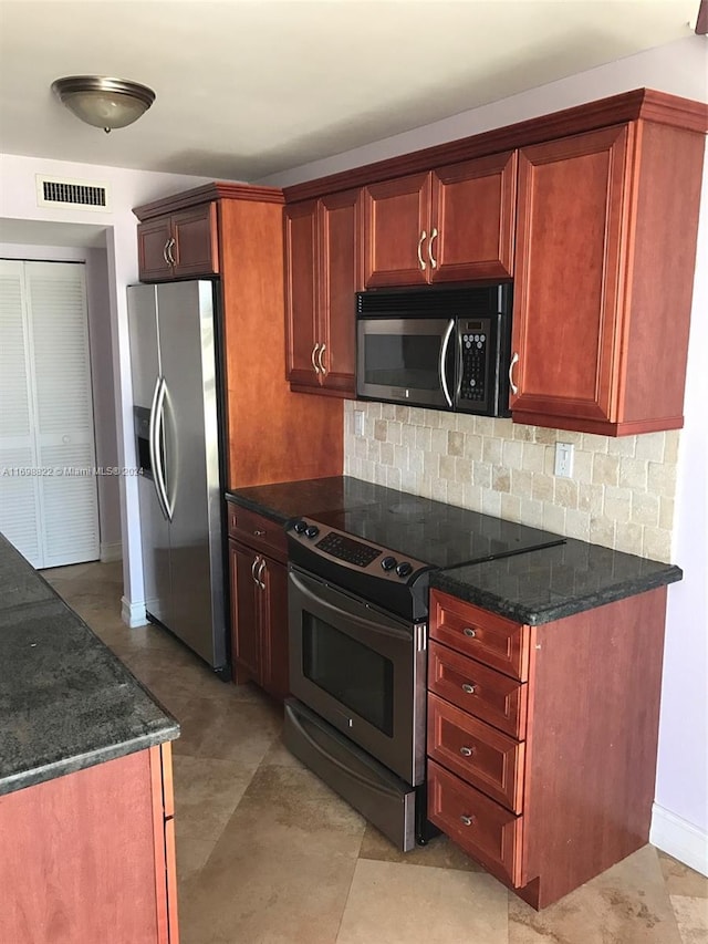 kitchen with backsplash, stainless steel appliances, and dark stone counters