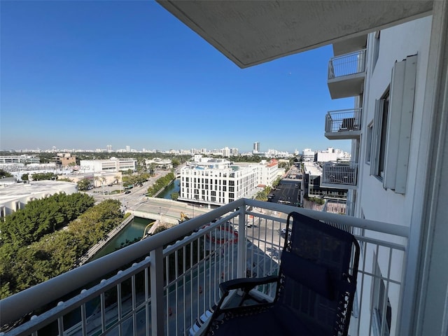 balcony with a water view and a city view