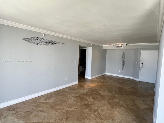 spare room featuring ornamental molding and baseboards