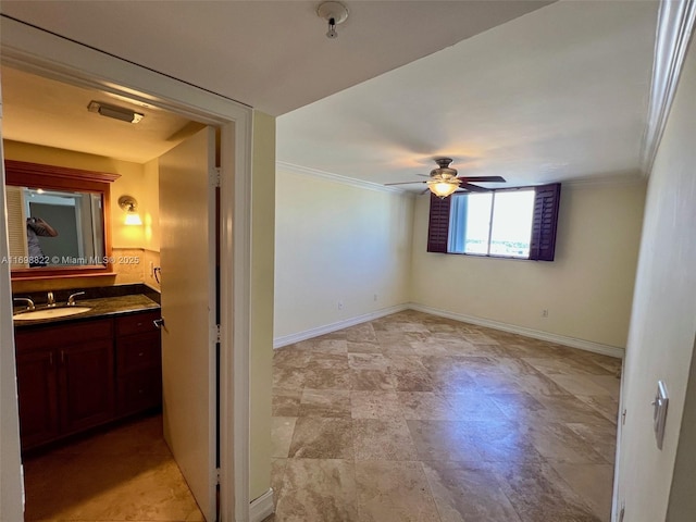 interior space with ornamental molding and baseboards