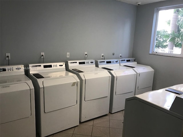 shared laundry area featuring light tile patterned floors and washer and dryer