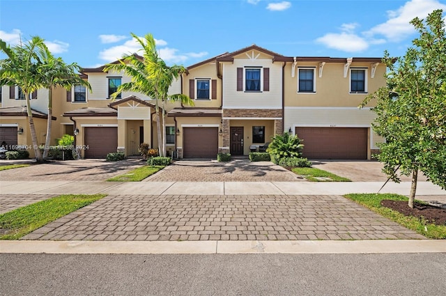 4641 Caspian Way, Davie, FL 33314 - view of property featuring stucco siding, a garage, driveway, and stone siding