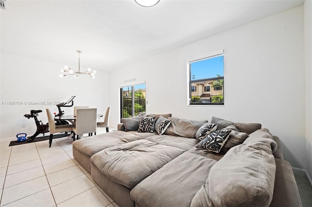 living room featuring light tile patterned floors and an inviting chandelier