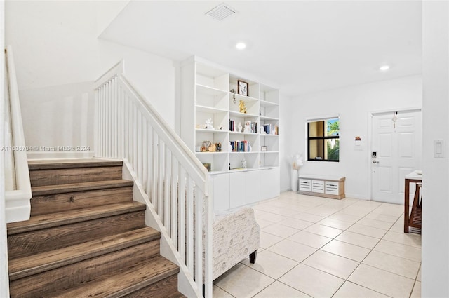 stairs featuring tile patterned floors