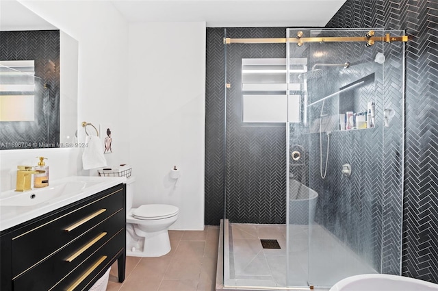 bathroom with tile patterned flooring, vanity, toilet, and an enclosed shower