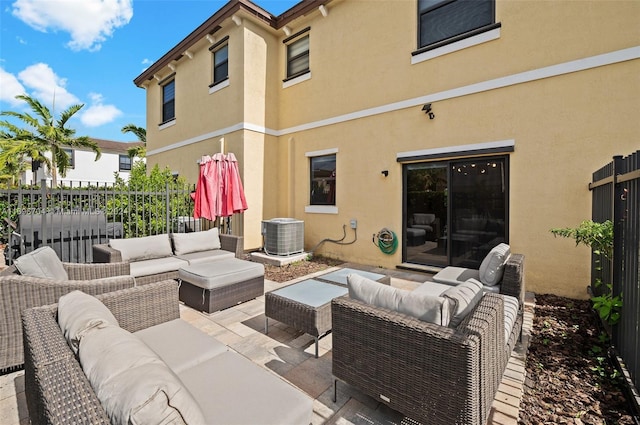 view of patio / terrace with an outdoor living space and central AC