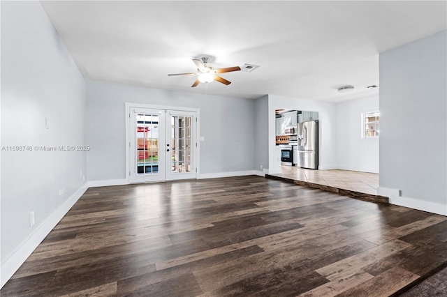 unfurnished living room with french doors, visible vents, a ceiling fan, wood finished floors, and baseboards