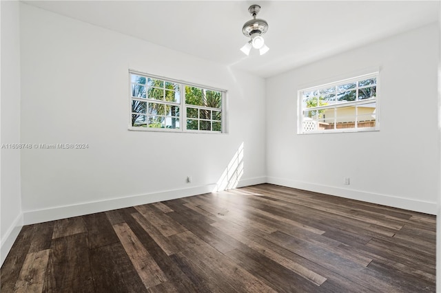 unfurnished room featuring dark wood-type flooring