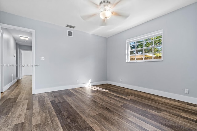 unfurnished room featuring ceiling fan and dark wood-type flooring