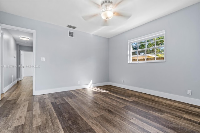 spare room with baseboards, visible vents, ceiling fan, and wood finished floors