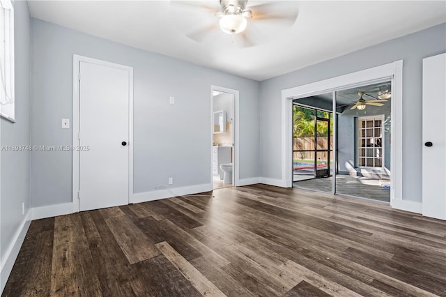 empty room featuring ceiling fan, baseboards, and wood finished floors