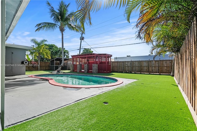 view of swimming pool with a patio area and a lawn