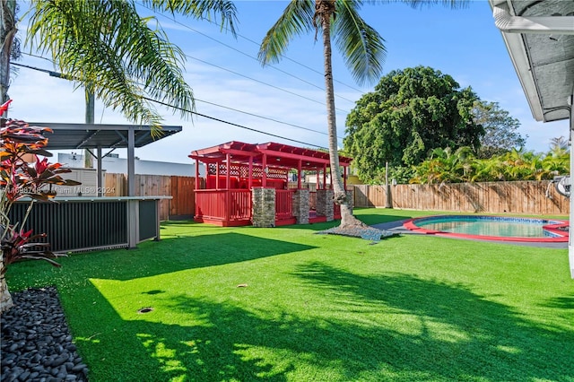 view of yard with a fenced in pool and a pergola