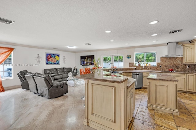 kitchen featuring dishwasher, a kitchen island with sink, black electric stovetop, wall chimney exhaust hood, and a textured ceiling