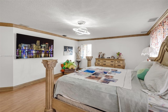 bedroom featuring a textured ceiling, hardwood / wood-style flooring, and crown molding