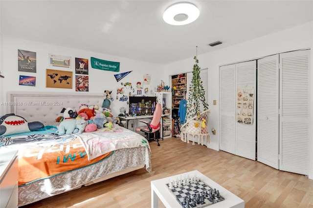 bedroom with a closet and hardwood / wood-style floors