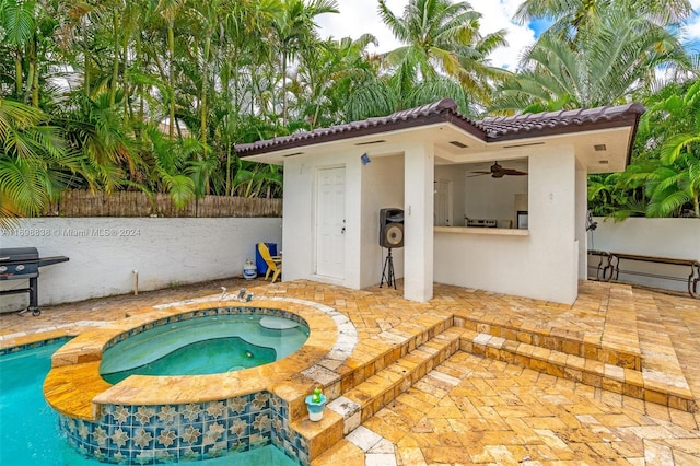 view of pool featuring an in ground hot tub and a patio