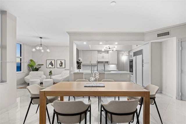 dining room with light tile patterned flooring, sink, and a chandelier