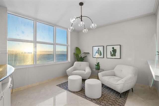 sitting room with a chandelier, crown molding, a water view, and light tile patterned flooring