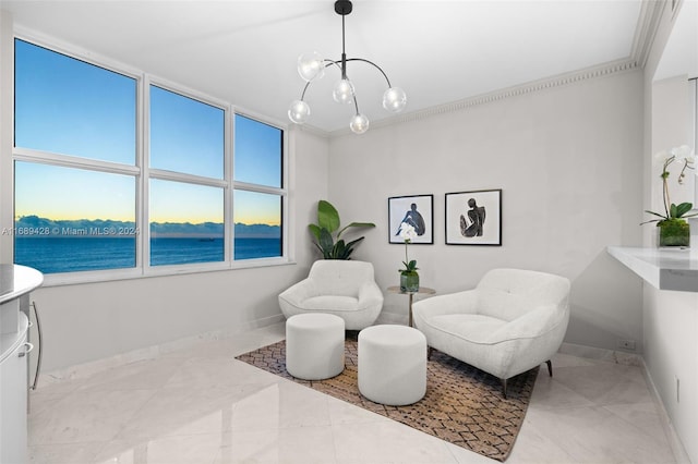 living area featuring a water view, an inviting chandelier, and crown molding