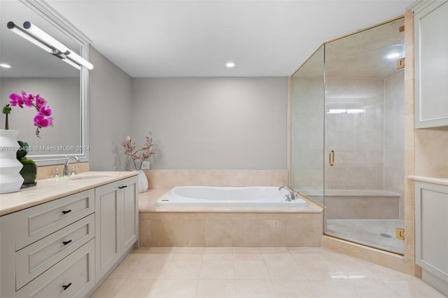 bathroom featuring tile patterned flooring, vanity, and separate shower and tub