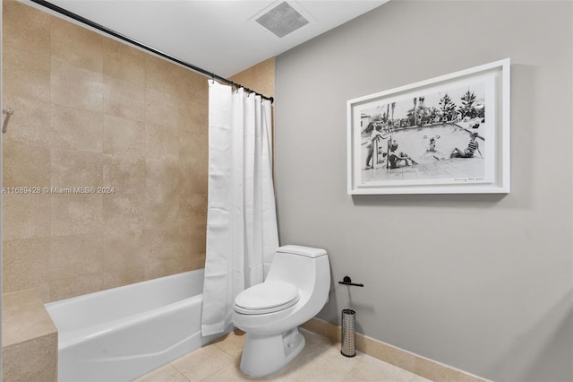 bathroom with tile patterned floors, toilet, and shower / tub combo