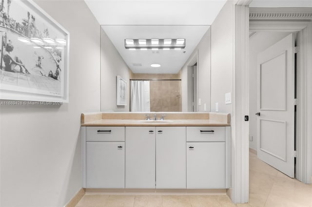 bathroom featuring tile patterned floors, vanity, and curtained shower