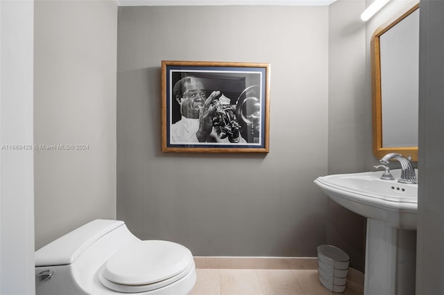 bathroom featuring tile patterned flooring, toilet, and sink