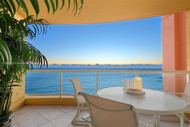 balcony featuring a water and mountain view