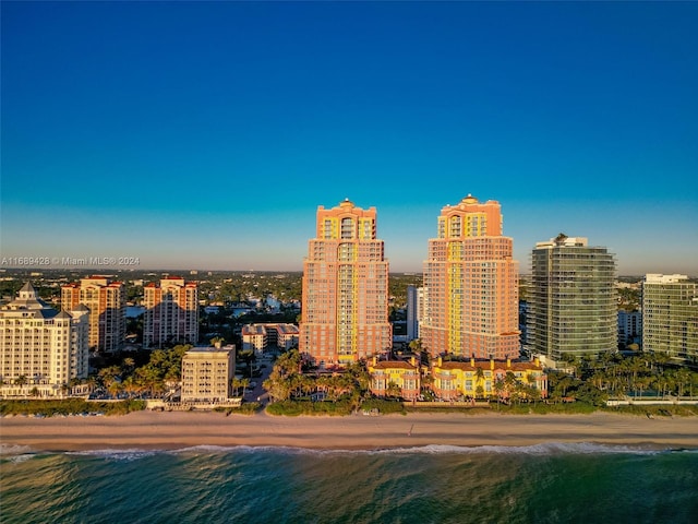 property's view of city with a water view and a view of the beach