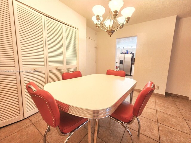 tiled dining area featuring a notable chandelier