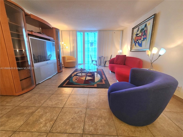 living room featuring tile patterned floors and expansive windows