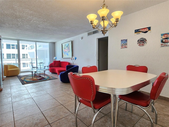 2030 S Ocean Dr Unit 604, Hallandale Beach, FL 33009 - dining area with a textured ceiling, a chandelier, a textured wall, and light tile patterned floors