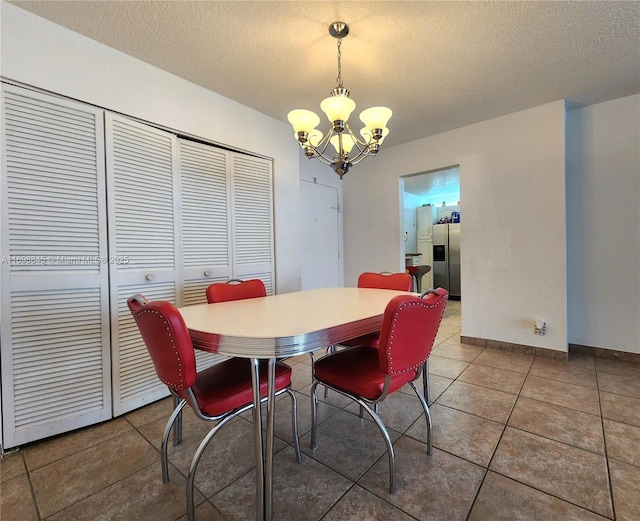 2030 S Ocean Dr Unit 604, Hallandale Beach, FL 33009 - tiled dining area with a chandelier, a textured ceiling, and baseboards