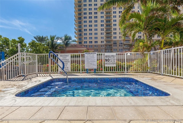 view of swimming pool with a community hot tub